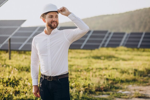 Young architect standing by solar panels