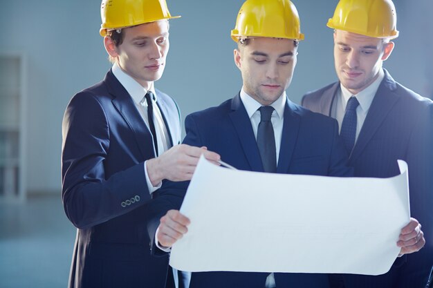 Young architects discussing the sketch of new building