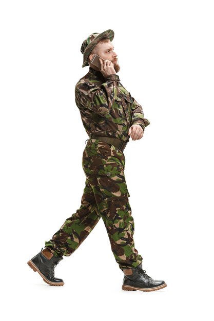 Young army soldier wearing camouflage uniform isolated on white