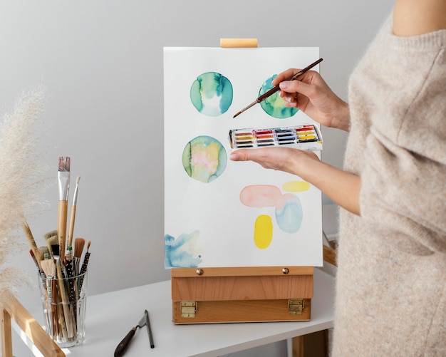 Young artist painting with watercolors