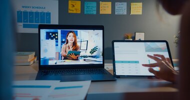 Young asia financial student ladies watching lesson online and studying with laptop and tablet in living room from home at night