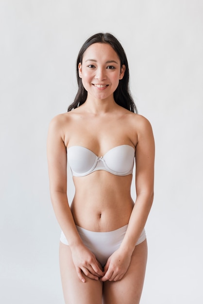 Young Asian brunette in bra and underpants
