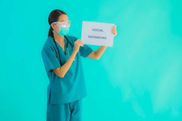  young asian doctor woman wear mask show Social distancing on paper board