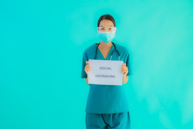  young asian doctor woman wear mask show Social distancing on paper board