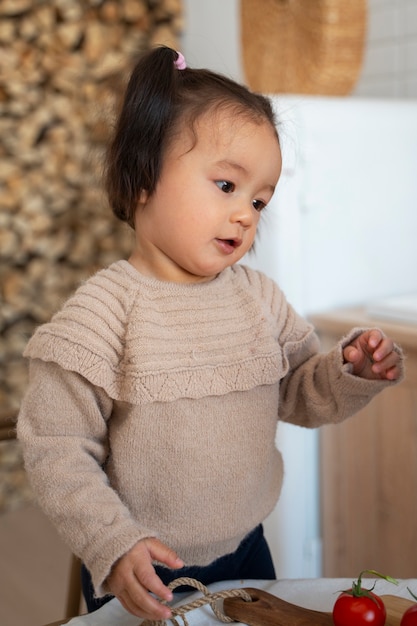 Free photo young asian girl in the kitchen at home