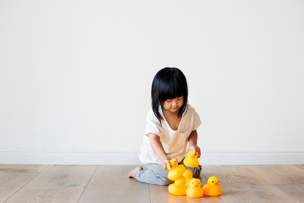 Free photo young asian girl playing alone