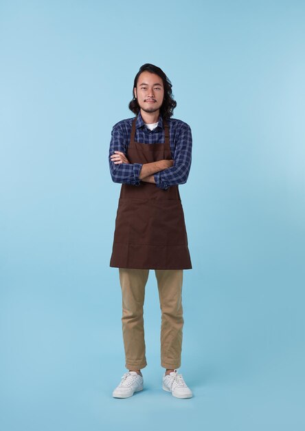 young asian man barista bartender employee in apron work in coffee shop hold hands crossed folded