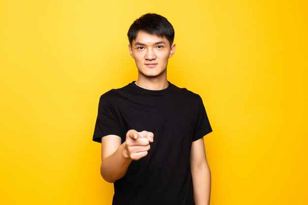 Young asian man pointing finger