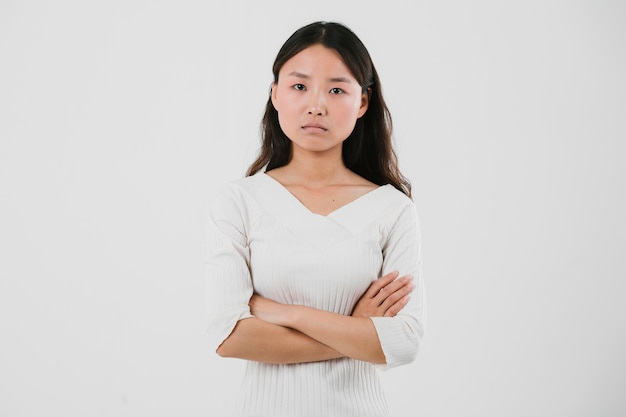 Free photo young asian woman being serious