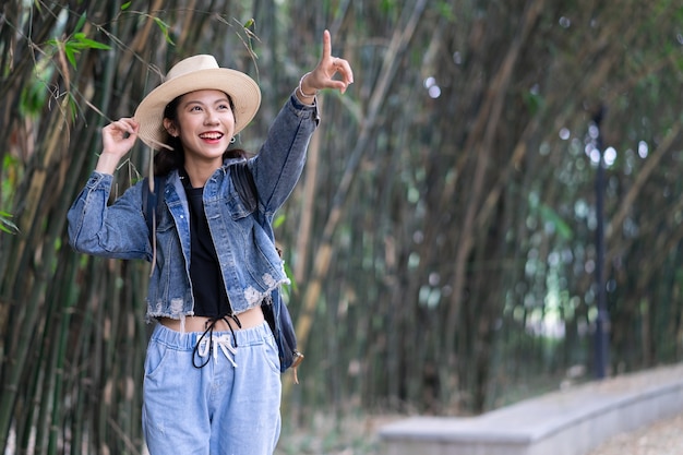 Young asian woman explores the forest on holiday