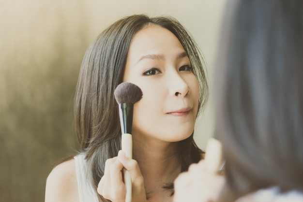 Free Photo young asian woman make up yourself