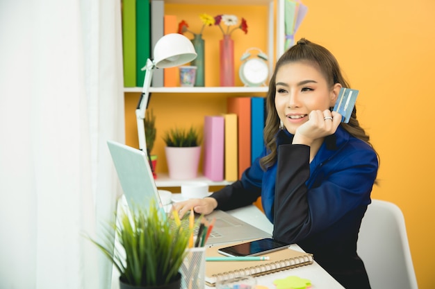 Young asian woman paying with credit card