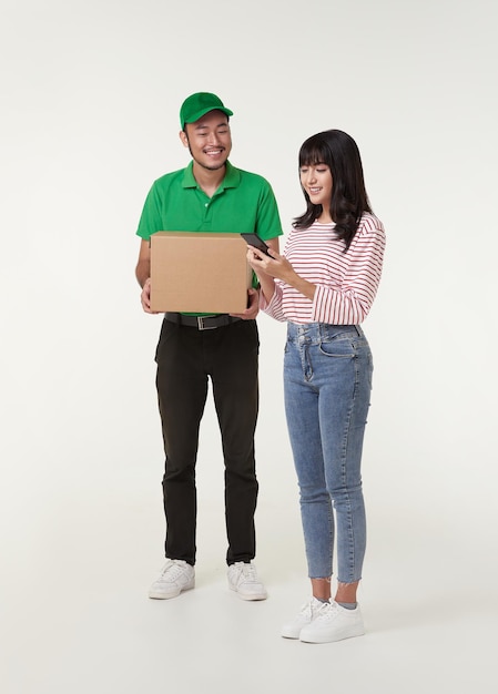Young asian woman receiving parcel from delivery man delivery service smart phone application