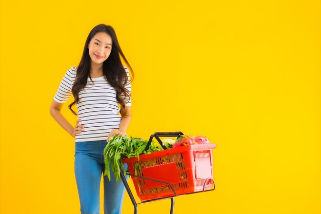 young asian woman shopping grocery from supermarket and cart