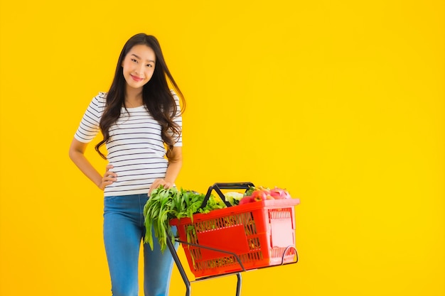 young asian woman shopping grocery from supermarket and cart