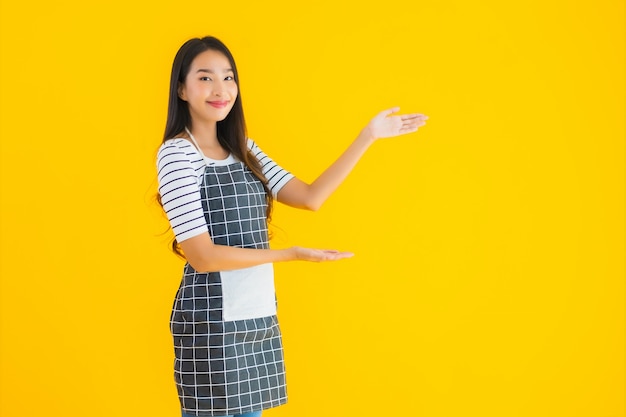 Young asian woman wear apron with smile happy