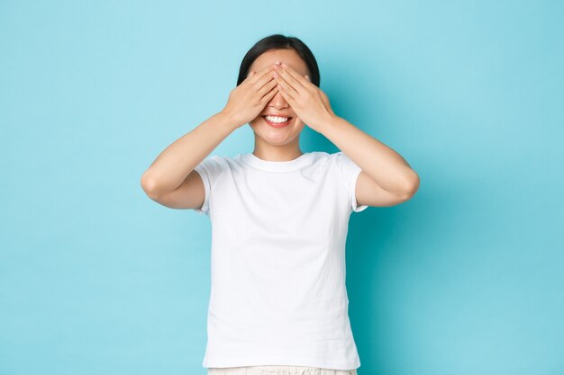 Young Asian woman wearing casual T-shirt posing