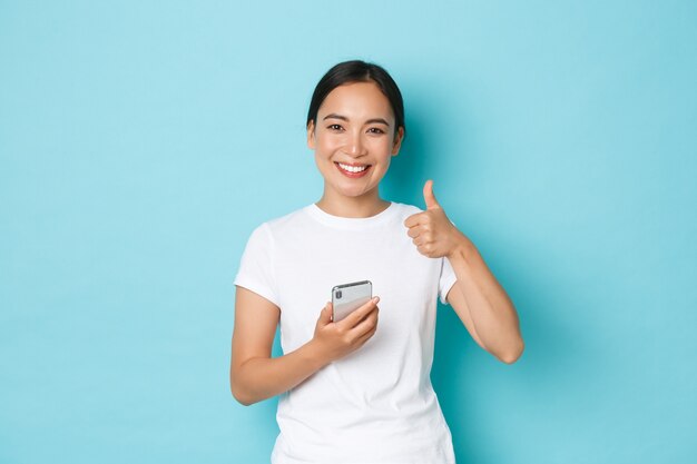Young Asian woman wearing casual T-shirt posing