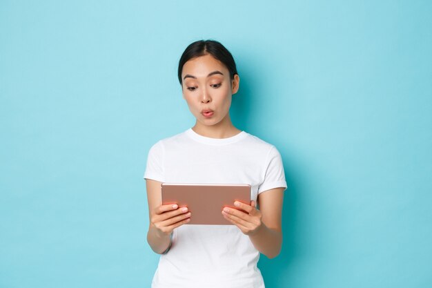 Young Asian woman wearing casual T-shirt posing