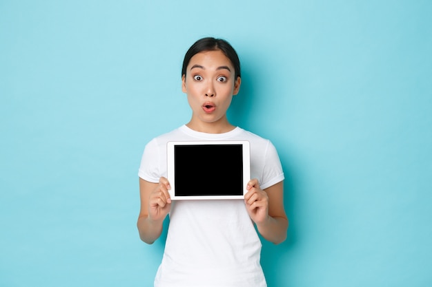 Young Asian woman wearing casual T-shirt posing