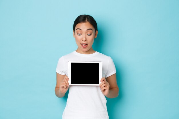 Young Asian woman wearing casual T-shirt posing