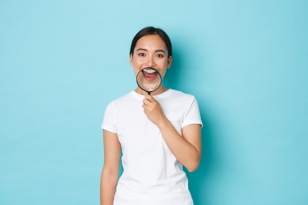 Free photo young asian woman wearing casual t-shirt posing