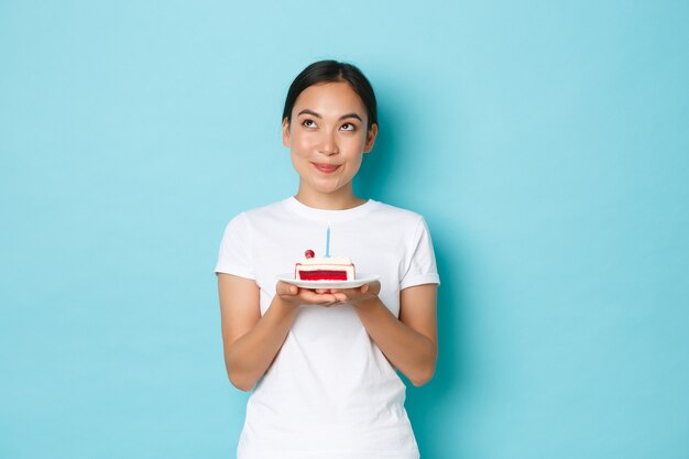 Young Asian woman wearing casual T-shirt posing