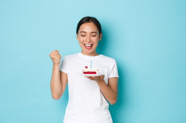 Young Asian woman wearing casual T-shirt posing