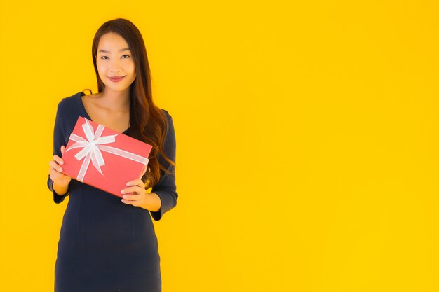 молодая азиатская женщина с подарочной коробкой
