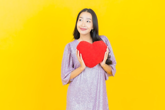 young asian woman with heart pillow