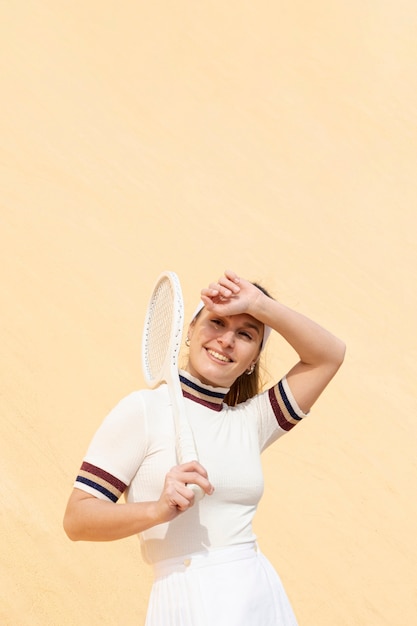 Young athlete holding tennis racket on shoulder