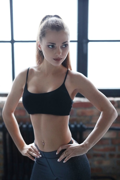 Young athletic woman doing her exercise routine at home