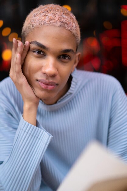 young attractive african american man in cafe, fashion shooting. Paris