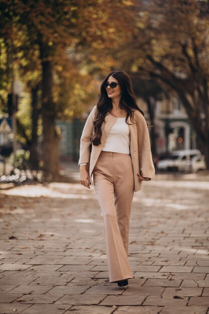 Young attractive business woman walking in the street