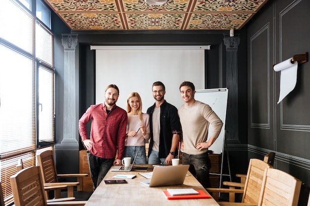 Young attractive colleagues standing and coworking