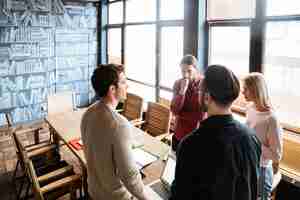 Free photo young attractive colleagues standing while working