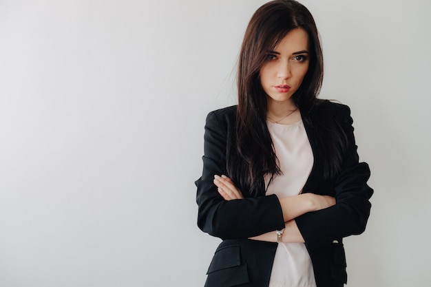 Young attractive emotional girl in business-style clothes