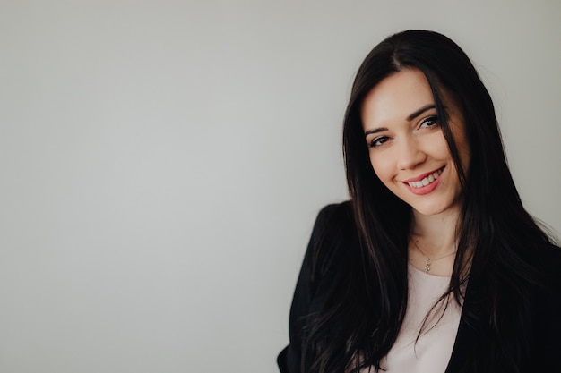 Young attractive emotional girl in businessstyle clothes 