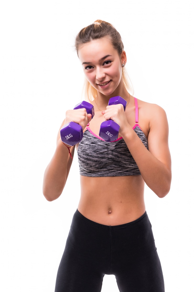 Free Photo young attractive fitness girl woman make different aerobics kick exercises with dumbbells on white dressed up in sportswear