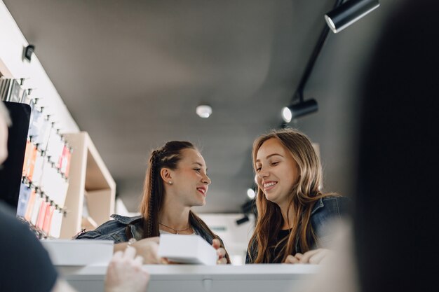 Young attractive girls in store buying. concept of buying at store.