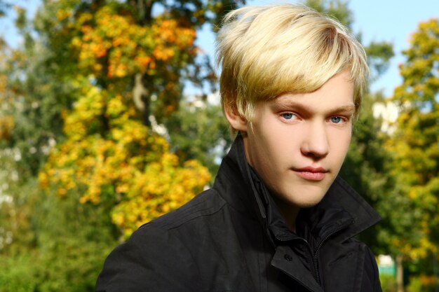 Young and attractive guy posing in park