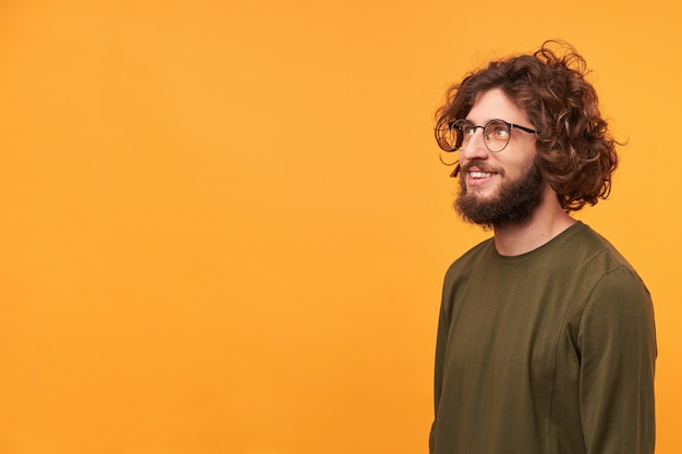 Young attractive handsome bearded guy in glasses feels delighted gladden amazed