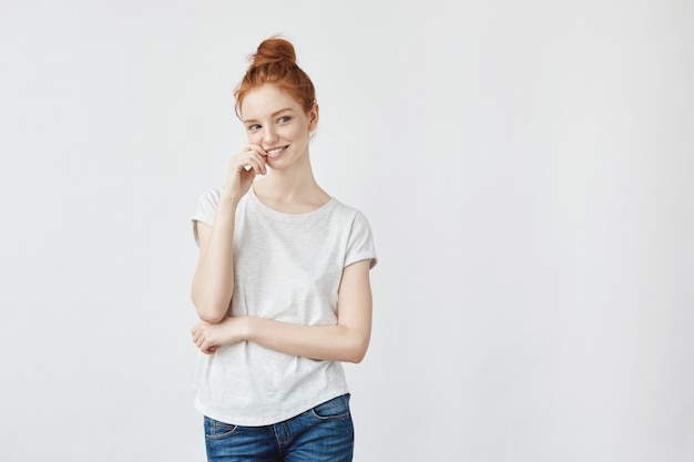 Young attractive playful woman with foxy hair smiling.