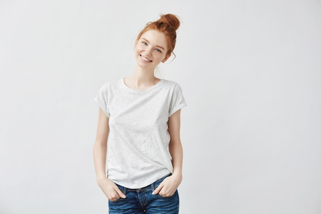 Free photo young attractive redhead girl smiling looking at camera. isolated on white background. copy space.