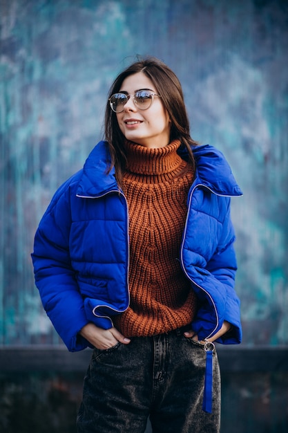 Free photo young attractive woman in blue winter jacket