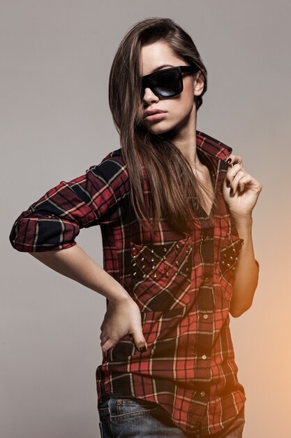Young attractive woman in shirt and sunglasses