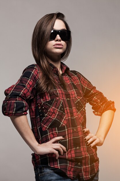 Young attractive woman in shirt and sunglasses