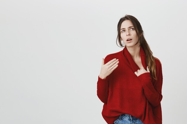 Young attractive woman in sweater feel hot