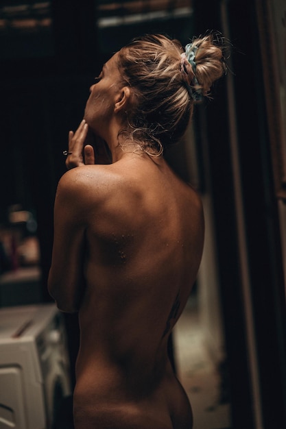 Young attractive woman takes a shower in a tropical location