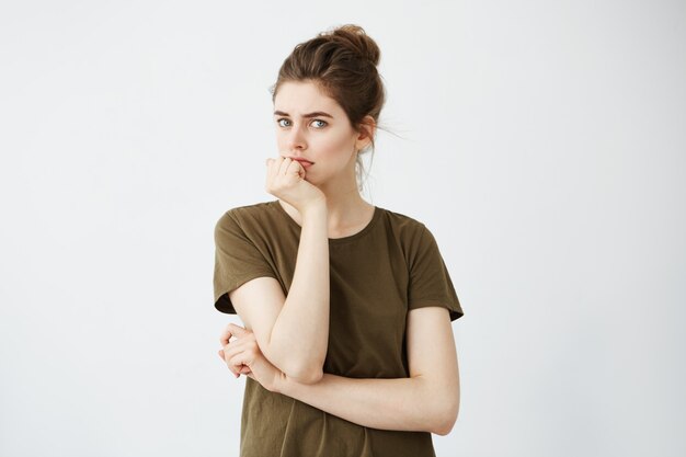 Young attractive woman thinking with hand on chin.